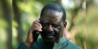 Azimio leader Raila Odinga in a phone call during Azimio Parliamentary Group Presser at Kalonzo Command Centre