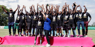 Soccer Assassins players celebrate with the trophy 