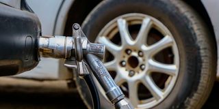 An LPG nozzle fuels a vehicle at a fueling station in Umoja 2, Nairobi