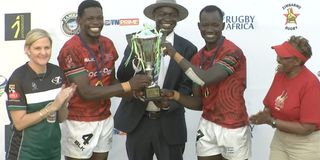 Kenya Sevens players celebrate with the trophy 