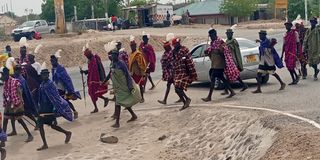 Turkana residents donned in traditional regalia arrive in Lodwar town 