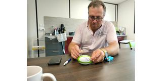 French fabrication company Comat Coffrages’ head Florian Bernard autographs a miniature rugby ball