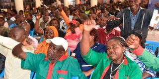 Teachers raise their hands at Kakamega Hill School 