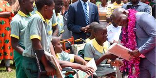 Kakamega governor Fernandes Barasa distributing best wishes success cards