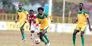 Mathare United's Christian Kitamba dribbles past Mully Children Family's Kelvin Omondi 