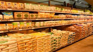 Customers countercheck the prices of maize flour at Clean-shelf Supermarket in Nakuru City