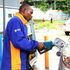 An attendant fuels a motor vehicle
