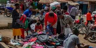 Parents buy second hand school bags by the roadside