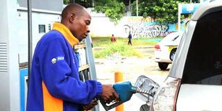 An attendant fuels a motor vehicle