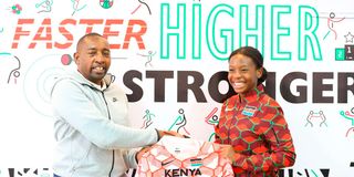 NOC-K secretary general Francis Mutuku hands young skier Ashley Ongong’a 