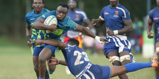 Austine Sikutwa (left) of KCB skips past Gideon Makumi of Strathmore Leos