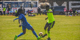 Posta Rangers midfielder Jackson Macharia (left) vies with Wisdom Academy midfielder Cliff Ochieng