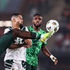 Nigeria's defender Ola Aina (left) vies for the ball 
