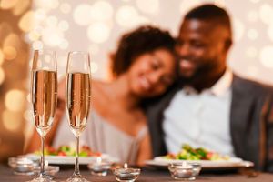 A couple celebrating Valentine's Day at a restaurant. 