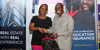 NMG Chairman Dr Wilfred Kiboro hands over prize to Ann Thoronjo