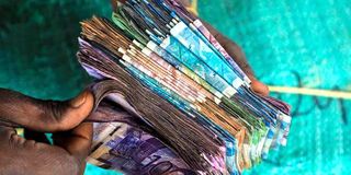  trader counts the day’s sales at Gikomba Market