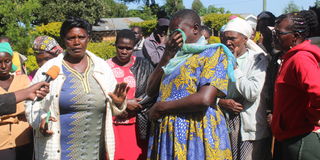 Mrs Ann Korir (left) leads villagers as they speak to journalists at the home of four