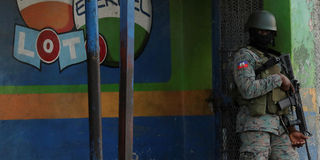 A Haitian soldier stands guard near the Toussaint Louverture International Airport