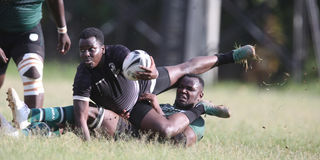 Mwamba RFC Brian Ayimba (top) is tackled by Nakuru RFC's Felix Okoth