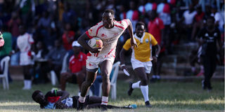 Charles Omondi (right) of Nondescript charges past Kenya Harlequins defender Evin Asena