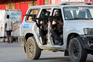 Police officers take part in a confrontation with gangs near the National Palace, in Port-au-Prince, Haiti March 21, 2024.