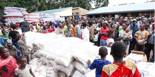 People affected by floods wait for humanitarian aid at Valley Bridge Primary School