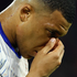 Kylian Mbappe holds his face 