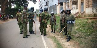 Anti-riot policemen advance on a group of protesters in Mtwapa on July 2, 2024.