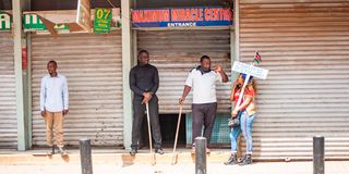 Security guards secure the entrance of a church along Latema road in Nairobi against protesters on July 2, 2024.