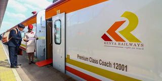 A standard gauge railway steward attends to a passenger