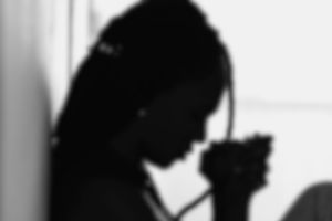 Silhouette meditative black woman praying