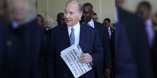 aga khan holding a daily nation newspaper