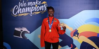 Kenya's Stency Neema poses after winning gold