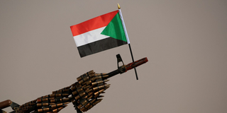 Sudanese national flag is attached to a machine gun of Paramilitary Rapid Support Forces (RSF) soldiers