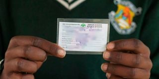A student displays his voter’s card 