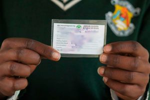 A student displays his voter’s card 