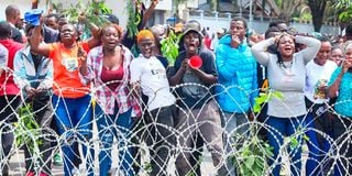 Raila Odinga's supporters mourn him outside Parliament