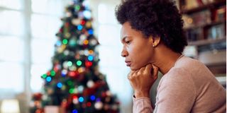 woman thinking of something while spending Christmas alone 