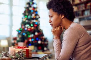 woman thinking of something while spending Christmas alone 