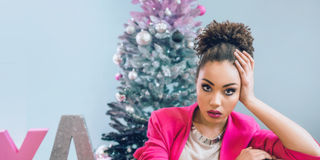 sad woman by the Christmas tree 