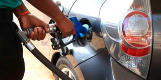 An attendant fuels a car at a Nyeri petrol station