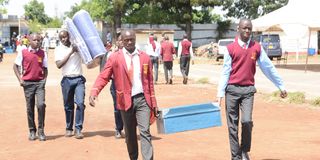 A Grade 10 student arrives at Nakuru High Senior School 