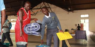 A Grade 10 student arrives at Nakuru High Senior School 