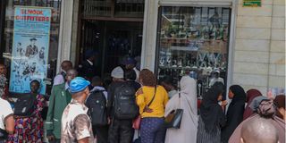 Parents, and guardians queue outside the School Outfitters 