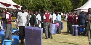 Parents, and guardians queue outside the School Outfitters 