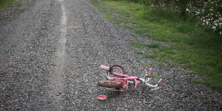 Children's bikecycle and shoe on stone road. missing children concept.