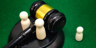 Parental Dolls with Child Dolls and Judge Gavel in Background 