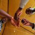 An IEBC official inks thr finger of an inmate at Kamiti Maximum Prison