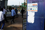 People walk past an advocacy poster against the spread of Ebola virus in Kampala, Uganda