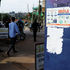 People walk past an advocacy poster against the spread of Ebola virus in Kampala, Uganda